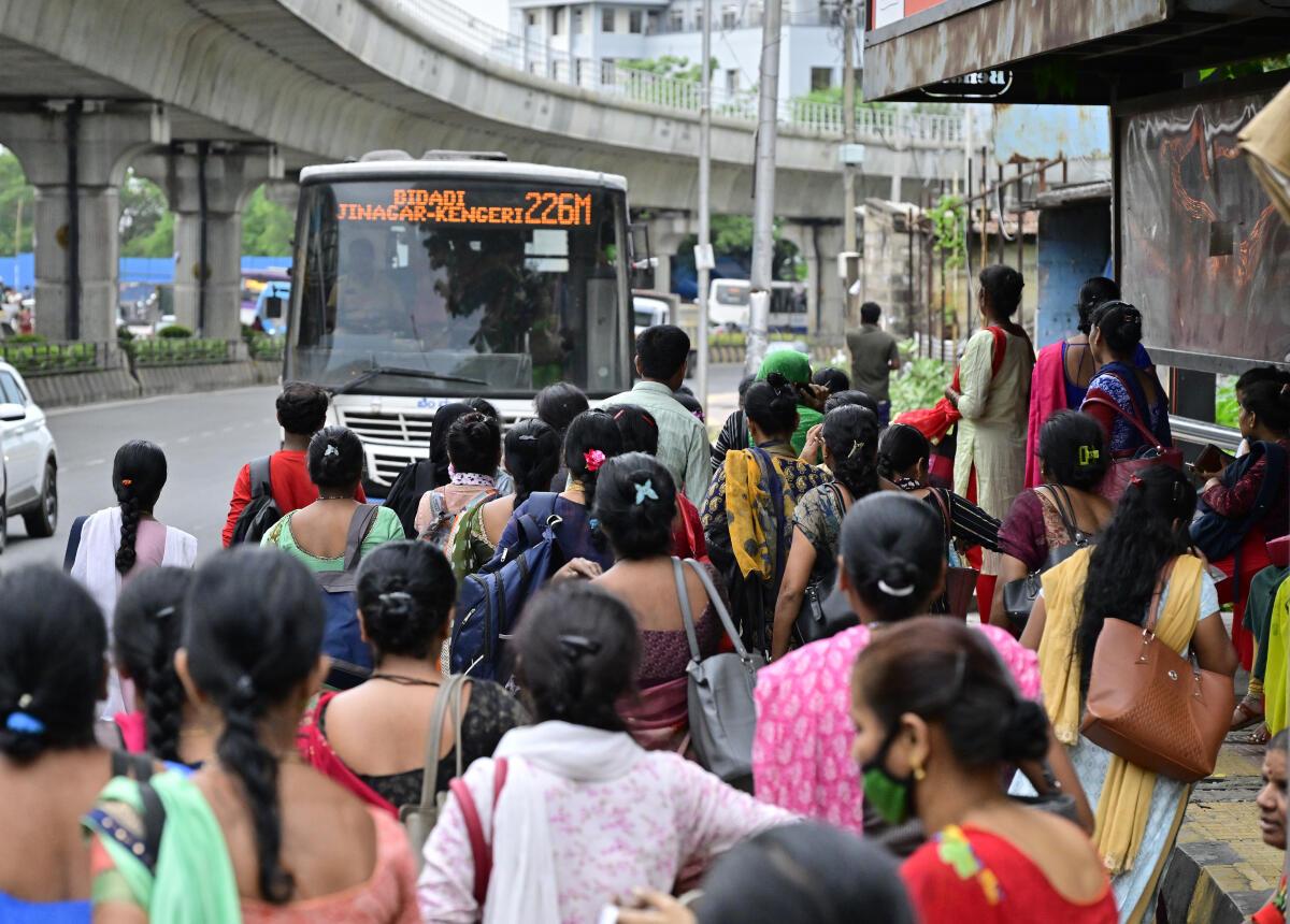Women wait for a government-run bus in Bengaluru, Karnataka.